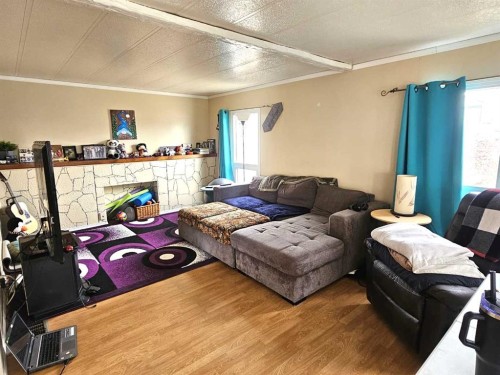 211 1St Avenue, Torrington, AB - Indoor Photo Showing Other Room With Fireplace