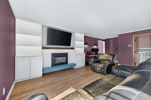 8 Slocan Road Sw, Calgary, AB - Indoor Photo Showing Living Room With Fireplace