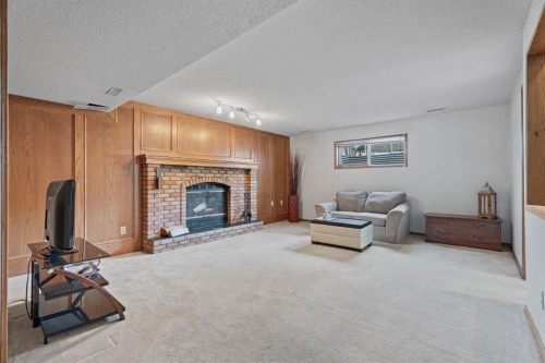 133 Carr Crescent, Okotoks, AB - Indoor Photo Showing Living Room With Fireplace