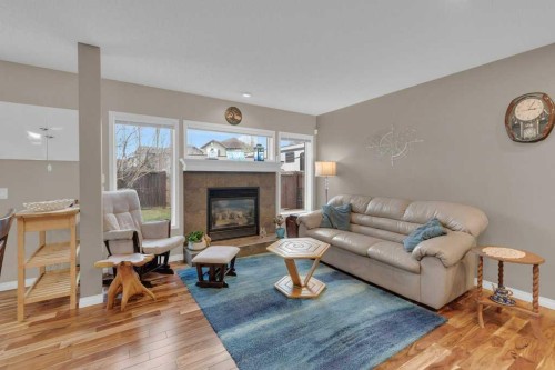 15 New Brighton Manor Se, Calgary, AB - Indoor Photo Showing Living Room With Fireplace