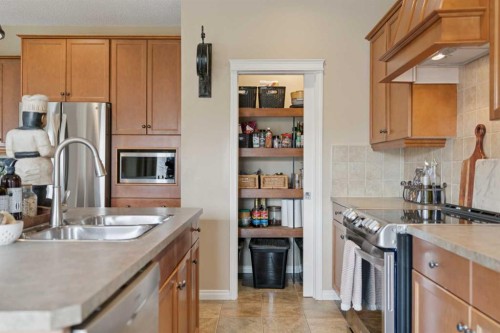 59 Heritage Cove, Heritage Pointe, AB - Indoor Photo Showing Kitchen With Double Sink