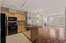 206-3651 Marda Link Sw, Calgary, AB  - Indoor Photo Showing Kitchen With Fireplace With Double Sink 