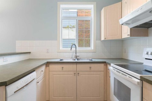 210-5703 5 Street Sw, Calgary, AB - Indoor Photo Showing Kitchen With Double Sink