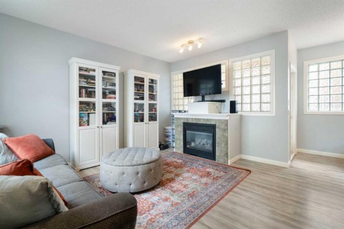 210-5703 5 Street Sw, Calgary, AB - Indoor Photo Showing Living Room With Fireplace