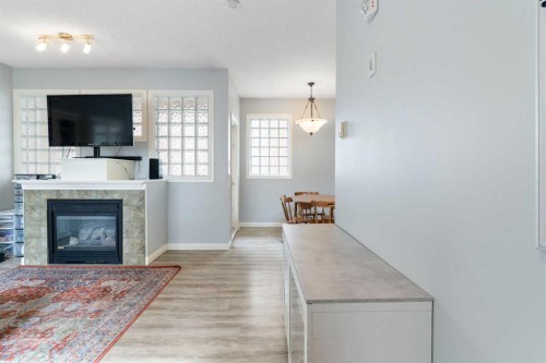 210-5703 5 Street Sw, Calgary, AB - Indoor Photo Showing Living Room With Fireplace
