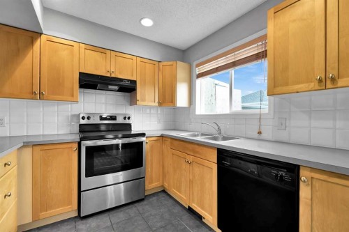 164 Bridleridge Gardens Sw, Calgary, AB - Indoor Photo Showing Kitchen With Double Sink