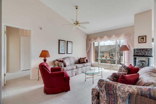 58 Evergreen Bay Sw, Calgary, AB - Indoor Photo Showing Living Room With Fireplace