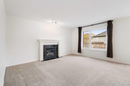 112 Everridge Drive Sw, Calgary, AB - Indoor Photo Showing Living Room With Fireplace
