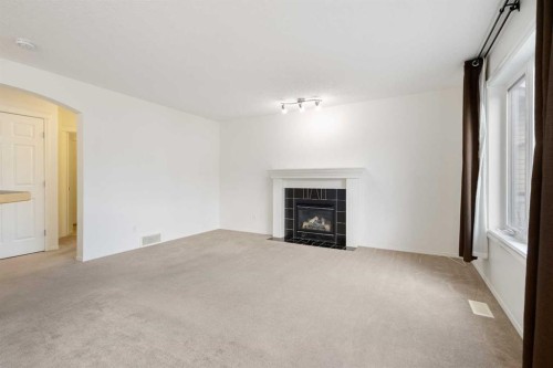 112 Everridge Drive Sw, Calgary, AB - Indoor Photo Showing Living Room With Fireplace