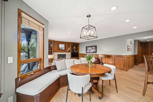 527 Scimitar Bay Nw, Calgary, AB - Indoor Photo Showing Dining Room With Fireplace
