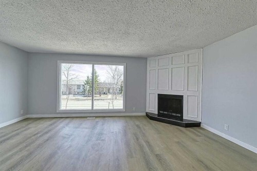 71 Falton Drive Ne, Calgary, AB - Indoor Photo Showing Living Room With Fireplace