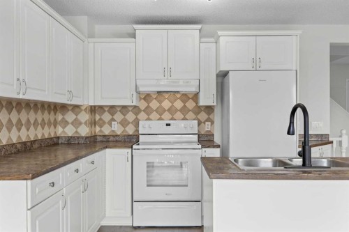 289 Hidden Spring Green Nw, Calgary, AB - Indoor Photo Showing Kitchen With Double Sink