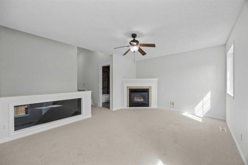 289 Hidden Spring Green Nw, Calgary, AB - Indoor Photo Showing Living Room With Fireplace
