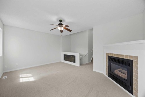 289 Hidden Spring Green Nw, Calgary, AB - Indoor Photo Showing Living Room With Fireplace