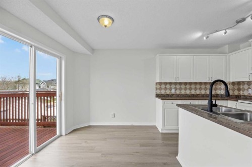 289 Hidden Spring Green Nw, Calgary, AB - Indoor Photo Showing Kitchen With Double Sink