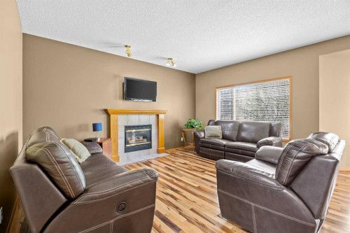 30 Gleneagles View, Cochrane, AB - Indoor Photo Showing Living Room With Fireplace