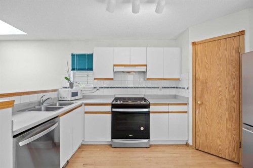 242 Hidden Spring Mews Nw, Calgary, AB - Indoor Photo Showing Kitchen With Double Sink
