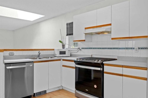242 Hidden Spring Mews Nw, Calgary, AB - Indoor Photo Showing Kitchen With Double Sink