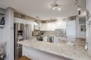25-200 Sandstone Drive Nw, Calgary, AB  - Indoor Photo Showing Kitchen With Stainless Steel Kitchen With Double Sink With Upgraded Kitchen 