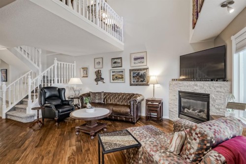 25-200 Sandstone Drive Nw, Calgary, AB - Indoor Photo Showing Living Room With Fireplace