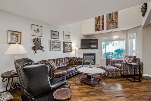 25-200 Sandstone Drive Nw, Calgary, AB - Indoor Photo Showing Living Room With Fireplace