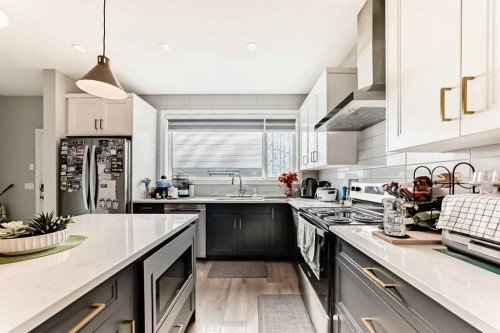 15053 37 Street Sw, Calgary, AB - Indoor Photo Showing Kitchen With Double Sink With Upgraded Kitchen