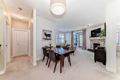 116-1005A Westmount Drive, Strathmore, AB - Indoor Photo Showing Dining Room With Fireplace