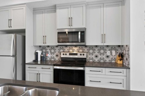 394 Sundown Road, Cochrane, AB - Indoor Photo Showing Kitchen With Double Sink With Upgraded Kitchen