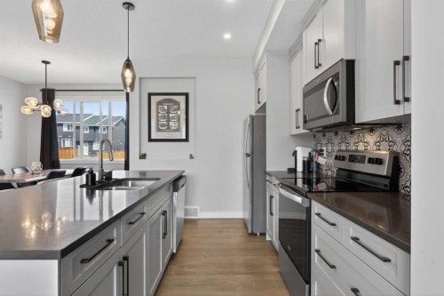 394 Sundown Road, Cochrane, AB - Indoor Photo Showing Kitchen With Double Sink With Upgraded Kitchen
