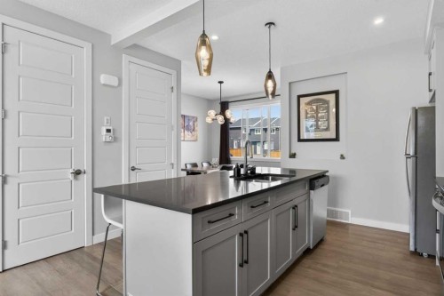 394 Sundown Road, Cochrane, AB - Indoor Photo Showing Kitchen With Double Sink With Upgraded Kitchen