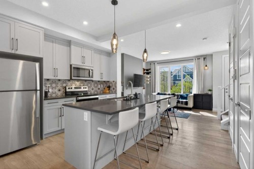 394 Sundown Road, Cochrane, AB - Indoor Photo Showing Kitchen With Upgraded Kitchen