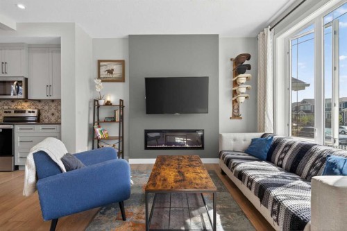 394 Sundown Road, Cochrane, AB - Indoor Photo Showing Living Room With Fireplace
