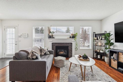 94 West Springs Way Sw, Calgary, AB - Indoor Photo Showing Living Room With Fireplace