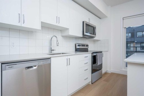 302-8535 19 Avenue Se, Calgary, AB - Indoor Photo Showing Kitchen With Stainless Steel Kitchen With Upgraded Kitchen