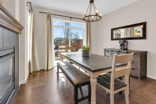 26 Heritage Landing, Cochrane, AB - Indoor Photo Showing Dining Room With Fireplace
