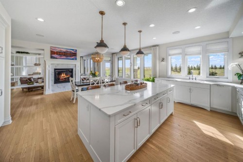 103 Brome Bend, Rural Rocky View County, AB - Indoor Photo Showing Kitchen With Fireplace With Upgraded Kitchen