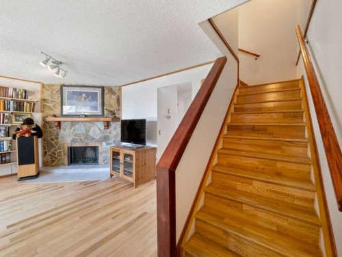 143 Erin Mount Place Se, Calgary, AB - Indoor Photo Showing Other Room With Fireplace