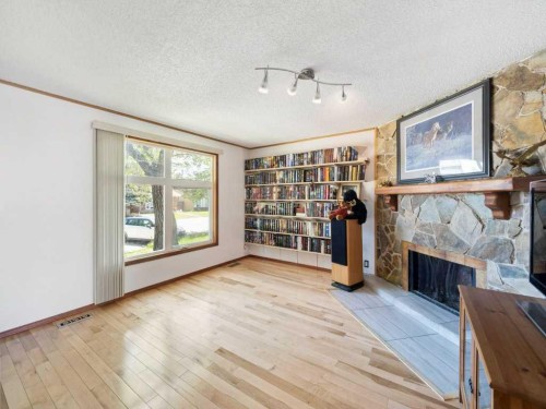 143 Erin Mount Place Se, Calgary, AB - Indoor Photo Showing Other Room With Fireplace