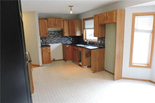 176 Woodside Road Nw, Airdrie, AB - Indoor Photo Showing Kitchen With Double Sink