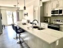 217-4350 Seton Drive Se, Calgary, AB  - Indoor Photo Showing Kitchen With Stainless Steel Kitchen With Double Sink With Upgraded Kitchen 