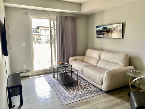 217-4350 Seton Drive Se, Calgary, AB - Indoor Photo Showing Living Room