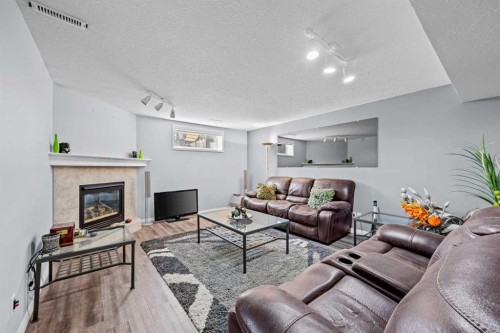 187 West Lakeview Circle, Chestermere, AB - Indoor Photo Showing Living Room With Fireplace