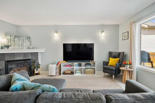 90 Elgin Drive Se, Calgary, AB - Indoor Photo Showing Living Room With Fireplace