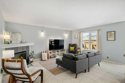 90 Elgin Drive Se, Calgary, AB - Indoor Photo Showing Living Room With Fireplace