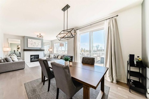 312 Auburn Shores Way Se, Calgary, AB - Indoor Photo Showing Dining Room With Fireplace