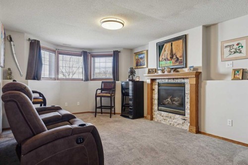 28 Westpoint Drive, Didsbury, AB - Indoor Photo Showing Living Room With Fireplace