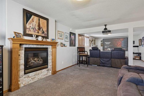 28 Westpoint Drive, Didsbury, AB - Indoor Photo Showing Living Room With Fireplace