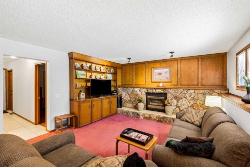 149 Edgehill Drive Nw, Calgary, AB - Indoor Photo Showing Living Room With Fireplace