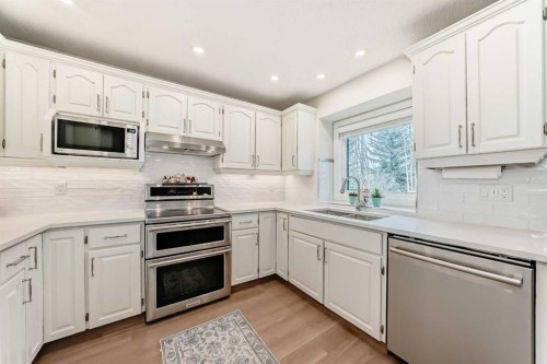 609 Downey Place, Okotoks, AB - Indoor Photo Showing Kitchen With Double Sink