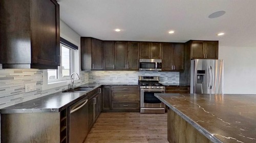 29 Sunrise Close Se, High River, AB - Indoor Photo Showing Kitchen With Double Sink